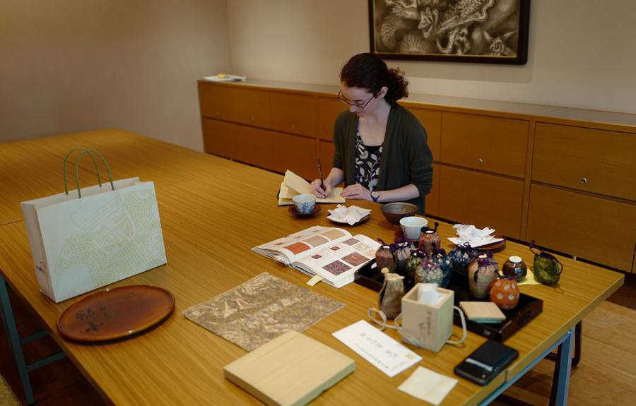 Student surrounded by Japanese artifacts